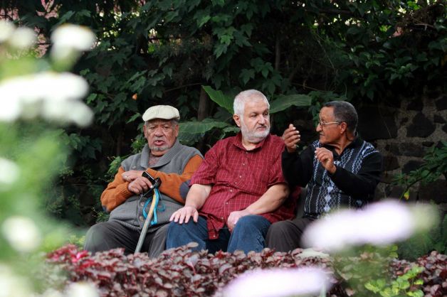 Armenians Paul Donigian, left, and Yohannes Vorperiam, center, sit with an unidentified person at right, in a garden in Addis Ababa, Ethiopia. Photo: Elias Asmare, AP